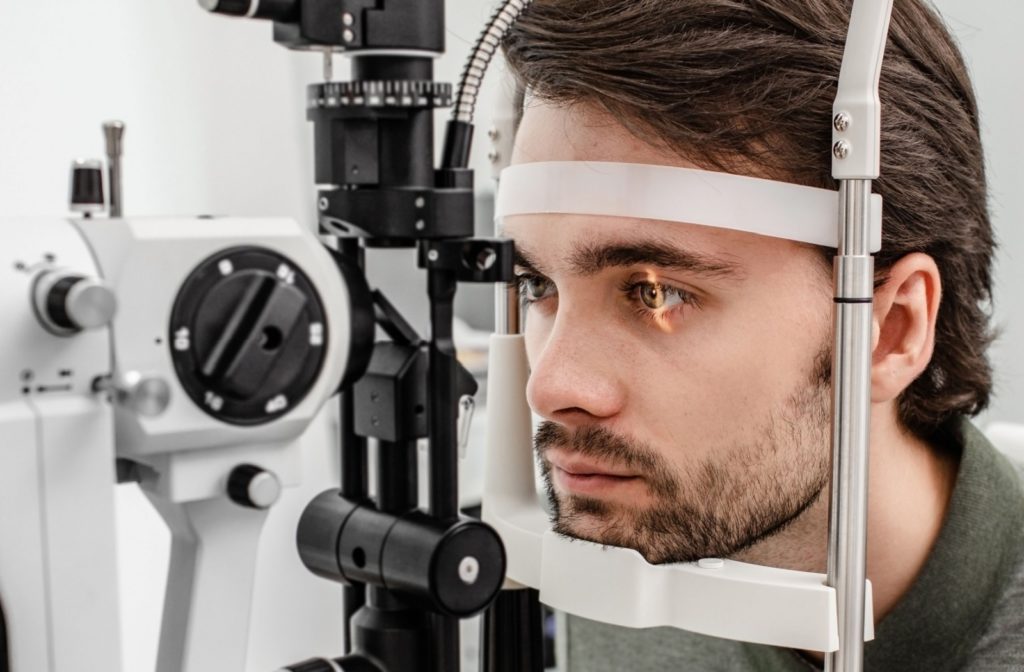A close-up of a man undergoing a slit-lamp eye examination.